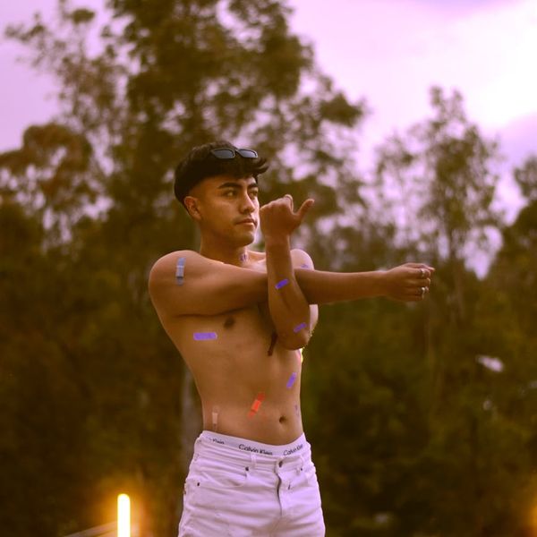 Silhouette of a man stretching against a calm, serene background, representing well-being.